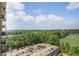 Elevated view of a parking lot surrounded by lush greenery and a sports field under a sunny sky at 795 Hammond Dr # 1012, Atlanta, GA 30328