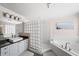 Bright bathroom with a glass block shower and a soaking tub at 1622 Gates Nw Pl, Atlanta, GA 30318