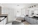 Bright bathroom with a glass block shower, soaking tub, and dual vanities at 1622 Gates Nw Pl, Atlanta, GA 30318