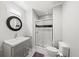 Bathroom featuring tiled floors, vanity with modern sink, and glass shower with a gray accent stripe at 1622 Gates Nw Pl, Atlanta, GA 30318