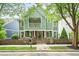 Charming two-story home with a welcoming front porch, fenced yard, and mature trees at 1622 Gates Nw Pl, Atlanta, GA 30318