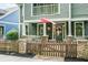 Inviting home exterior featuring a quaint picket fence and a charming front porch with stone accents at 1622 Gates Nw Pl, Atlanta, GA 30318