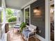 Cozy front porch featuring comfortable seating, stone accents, and a view of the landscaped surroundings at 1622 Gates Nw Pl, Atlanta, GA 30318