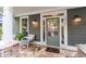 Welcoming front porch with stone flooring, comfortable seating, and a stylish entrance door at 1622 Gates Nw Pl, Atlanta, GA 30318