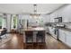 Kitchen with stainless appliances, island with seating, hardwood floors, and adjacent dining area at 1622 Gates Nw Pl, Atlanta, GA 30318