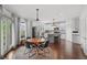 View of kitchen and dining area featuring an island and stainless steel refrigerator at 1622 Gates Nw Pl, Atlanta, GA 30318