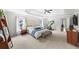 Spacious main bedroom with a tray ceiling, bench, and a Peloton bike at 1622 Gates Nw Pl, Atlanta, GA 30318