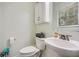 Half bathroom features toilet, sink, window, and medicine cabinet at 8767 N View Dr, Lithia Springs, GA 30122
