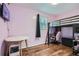 Bedroom with gray walls, wood-look floor, bunkbed, table and chair at 8767 N View Dr, Lithia Springs, GA 30122