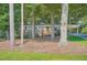 Single-story home with brick facade and covered parking nestled among mature trees at 8767 N View Dr, Lithia Springs, GA 30122