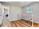 Hallway features wood-look flooring, stairs, and neutral gray walls at 8767 N View Dr, Lithia Springs, GA 30122