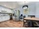Bright eat-in kitchen with stainless steel appliances, light blue walls, and wood laminate floors at 8767 N View Dr, Lithia Springs, GA 30122