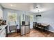 Eat-in kitchen features wood-look flooring, stainless fridge, natural light, and dining area at 8767 N View Dr, Lithia Springs, GA 30122