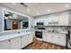 Bright kitchen with stainless appliances, white cabinets, and open view to living area at 8767 N View Dr, Lithia Springs, GA 30122