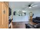Comfortable living room with wood floors, a ceiling fan, and a pass-through to the kitchen at 8767 N View Dr, Lithia Springs, GA 30122