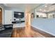 Well-lit living room with hardwood floors, a pass-through window, and entertainment setup at 8767 N View Dr, Lithia Springs, GA 30122