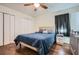 Bedroom with wood-look flooring, ceiling fan, a queen bed, and closet at 8767 N View Dr, Lithia Springs, GA 30122