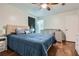 Bedroom with wood-look flooring, ceiling fan, a queen bed, closet, and crib at 8767 N View Dr, Lithia Springs, GA 30122