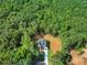 View of a modern farmhouse surrounded by mature trees on a verdant lot at 2335 Azalea Dr, Loganville, GA 30052