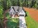 Attractive new home with a long driveway, nestled into wooded surroundings at 2335 Azalea Dr, Loganville, GA 30052
