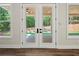 Double doors open to a screened porch with a peaceful wooded view at 2335 Azalea Dr, Loganville, GA 30052