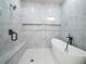 Luxurious bathroom with glass-enclosed shower, bench, rainfall shower head, and a freestanding bathtub at 2335 Azalea Dr, Loganville, GA 30052