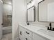 Luxurious bathroom with double vanity, modern fixtures, and tub/shower combination at 2335 Azalea Dr, Loganville, GA 30052