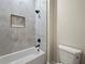 Clean bathroom with tub/shower combination, black hardware, and updated wall tile at 2335 Azalea Dr, Loganville, GA 30052