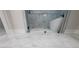 Luxurious bathroom featuring a modern glass-enclosed shower and a freestanding bathtub at 2335 Azalea Dr, Loganville, GA 30052