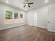 Spacious bedroom features luxury vinyl plank flooring, natural light, ceiling fan, and a closet at 2335 Azalea Dr, Loganville, GA 30052
