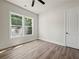 Well-lit bedroom with wood-look flooring, window, and a neutral color scheme at 2335 Azalea Dr, Loganville, GA 30052
