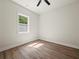 Bright bedroom with wood-look flooring and a neutral color scheme at 2335 Azalea Dr, Loganville, GA 30052