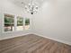 Dining room with a modern chandelier, ample natural light, and views of the backyard at 2335 Azalea Dr, Loganville, GA 30052