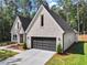 Attractive new home with light brick, a two-car garage and recently planted landscaping at 2335 Azalea Dr, Loganville, GA 30052