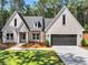 Charming, newly built home with light brick, manicured lawn, and a paved driveway at 2335 Azalea Dr, Loganville, GA 30052