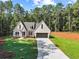 Beautiful new construction on a verdant lawn featuring an attached two car garage at 2335 Azalea Dr, Loganville, GA 30052