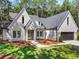 Charming new construction with light brick, lush lawn, and a paved walkway to the front door at 2335 Azalea Dr, Loganville, GA 30052