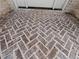 Close up of the brick herringbone pattern on the floor of the front porch at 2335 Azalea Dr, Loganville, GA 30052