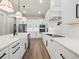 Modern kitchen featuring a large island, stainless steel appliances, and sleek white cabinetry at 2335 Azalea Dr, Loganville, GA 30052