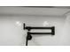 Kitchen with a sleek pot filler faucet mounted over a cooktop featuring white herringbone tile at 2335 Azalea Dr, Loganville, GA 30052