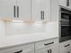 Close up view of the kitchen's sleek countertops and custom cabinets for an elevated experience at 2335 Azalea Dr, Loganville, GA 30052