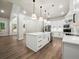 Open-concept kitchen with a large island, stainless steel appliances, and bright lighting at 2335 Azalea Dr, Loganville, GA 30052