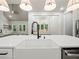 Spacious kitchen with island, farmhouse sink, stainless appliances, and an open floor plan at 2335 Azalea Dr, Loganville, GA 30052