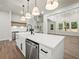 Bright open-concept kitchen featuring a large island, stainless steel appliances, and ample cabinet space at 2335 Azalea Dr, Loganville, GA 30052