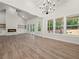 Spacious living room featuring a fireplace, high ceilings, large windows, and wood floors at 2335 Azalea Dr, Loganville, GA 30052