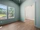 Bright living room featuring large windows offering scenic outdoor views and natural light at 2335 Azalea Dr, Loganville, GA 30052