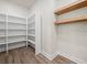 Walk-in pantry featuring ample shelving and wood floors at 2335 Azalea Dr, Loganville, GA 30052