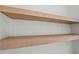 Close-up of the warm-toned wooden shelves against a clean, white wall at 2335 Azalea Dr, Loganville, GA 30052