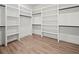 Spacious walk-in closet with custom shelving and hanging rods for organized storage at 2335 Azalea Dr, Loganville, GA 30052