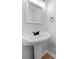 Clean powder room with pedestal sink, mirror, and wood flooring at 3078 Milford Chase Sw, Marietta, GA 30008